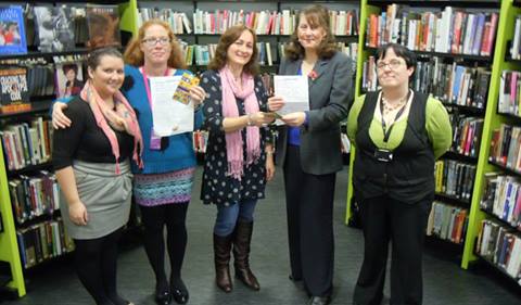 Wendy presenting awards to competition winners at Llanelli Library